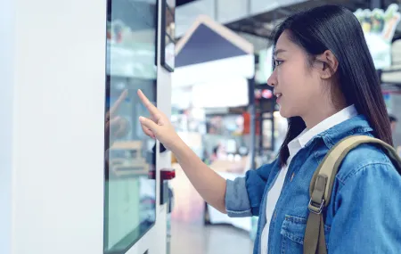 Vending_Asian woman buying coffee from a vending machine.png