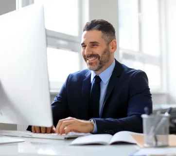 smiling-middle-aged-businessman-in-suit-working-on-2026-01-08-23-02-47-utc copie.jpg