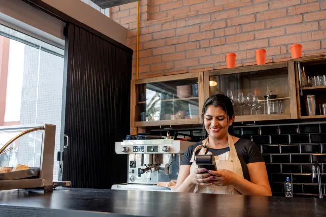 Shop owner managing her Ingenico Payment Terminal with Payment Terminal Management Systems